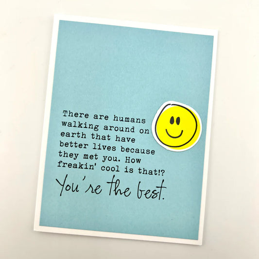 Card with a smiley face and motivational quote on a light blue background