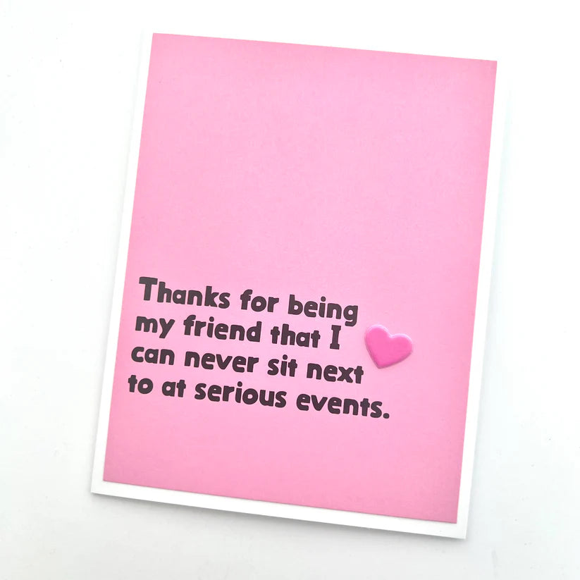 Pink card with humorous text and a heart on a white background