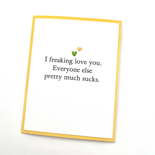 Card with text 'I freaking love you. Everyone else pretty much sucks.' on a white background