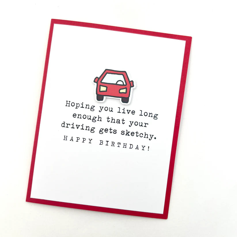 Birthday card with a red car illustration and humorous text on a white background