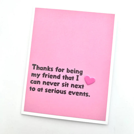 Pink card with humorous text and a heart on a white background