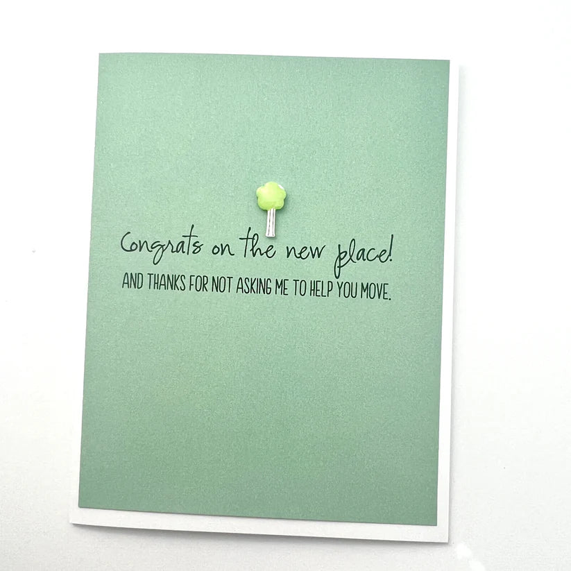 Green card with text 'Congrats on the new place' and a small decorative item on a white background